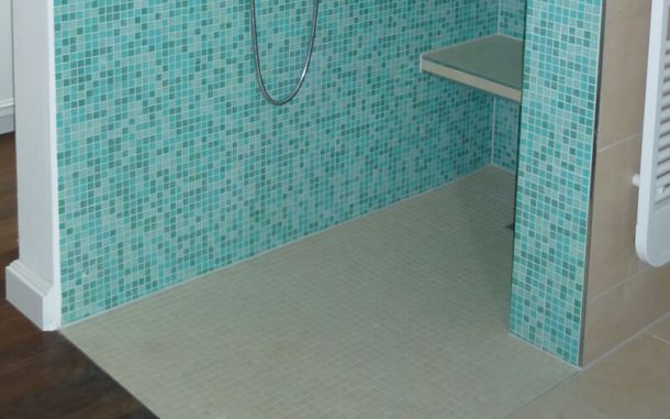 Gemauerte Dusche mit Mosaikfliesen.